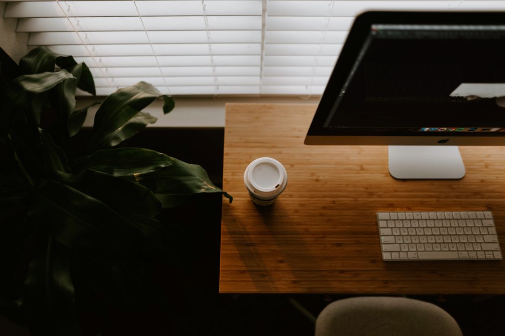 biurko z monitorem i kubkiem